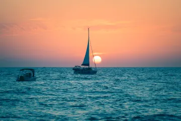 North Jetty: Sail Venice Sailboat Cruises Past the Setting Sun