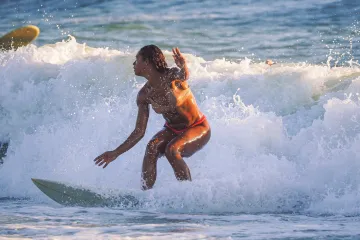 Lindsay Surfing with the Setting Sun