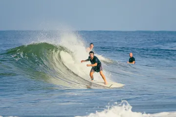 North Jetty, Ida: Wave Curling Behind Surfer