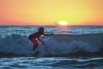 Lindsay Surfs at Sunset